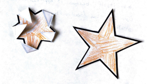 image of orange star on paper with folded corners next to an open flat orange star