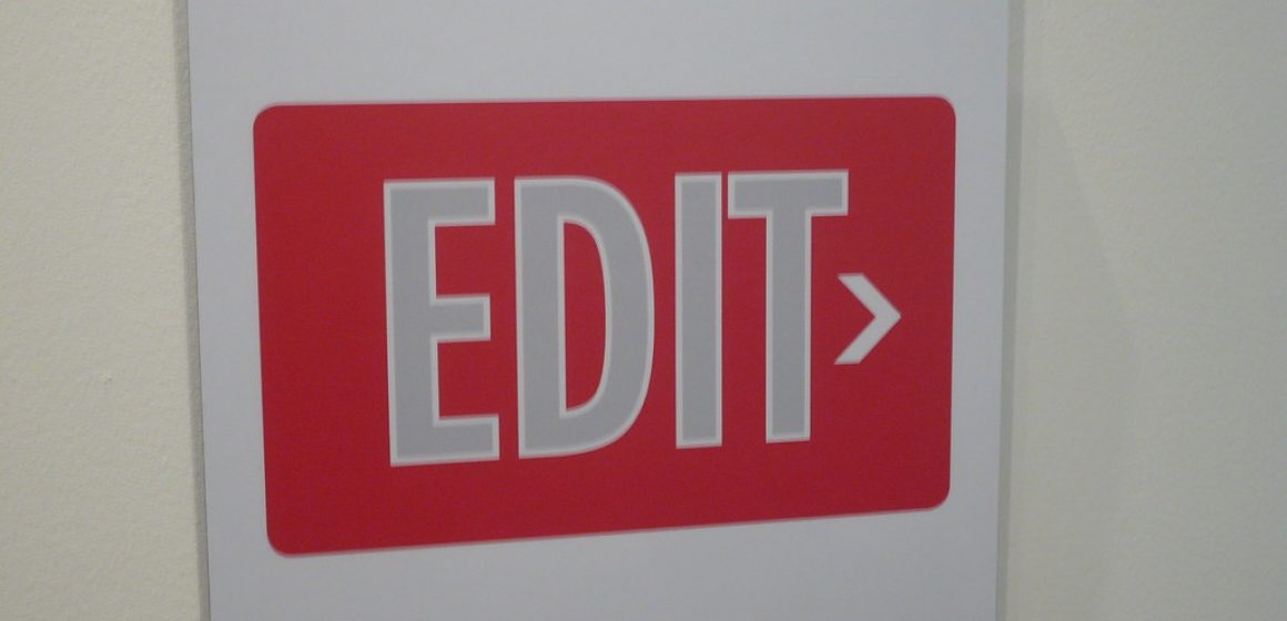 Sign with large bold letters saying "EDIT" with a small arrow to the right.
